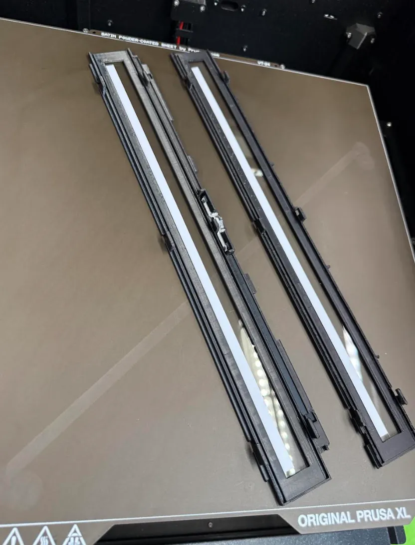 Pair of 3D printed scanner reading-glass unit housings on a Prusa XL print bed