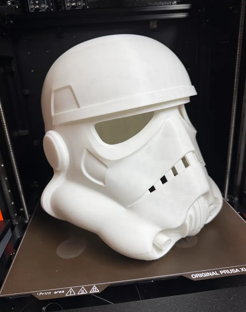 White 3D printed sci-fi trooper-style cosplay helmet on a Prusa XL print bed